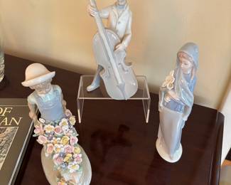 Lladro figures. Figure with floral wheelbarrow is not lladro