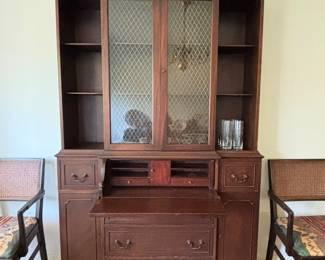 Smaller scale display cabinet with drop down surface