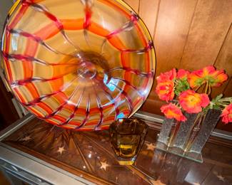 Art glass and details of wood top under glass on console table
