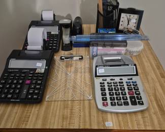 Desktop calculators, clock, utensil holder, tape dispenser, clip board
