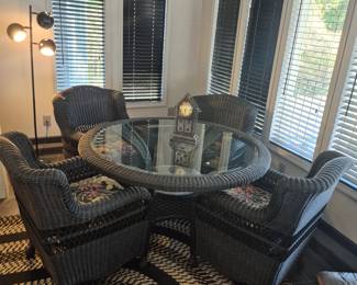 Beautiful patio or indoor high end vinyl wicker, with 4 heavy duty cushioned chairs, and matching glass top table.