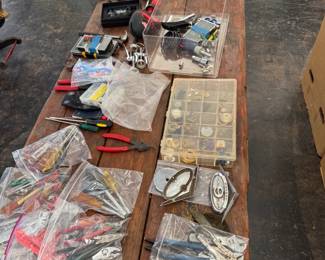 Variety of tools, vintage jewelry, and car emblems available