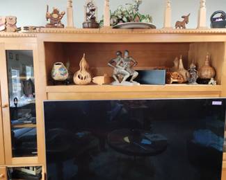 Wooden Entertainment Center with assorted Figurines, holding a 65 ' Samsung OLED TV