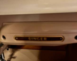 #65	Singer Brown 404 Sewing machine in Cabinet w/stool	 $45.00 			
