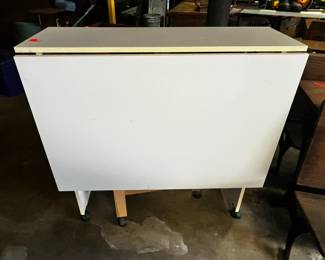 #173	laminate sewing table drop side on wheels 36x12-72x35	 $45.00 			
