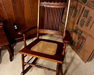 #76	Wooden Rocking Chair w/cane seat and carved back	 $65.00 			
