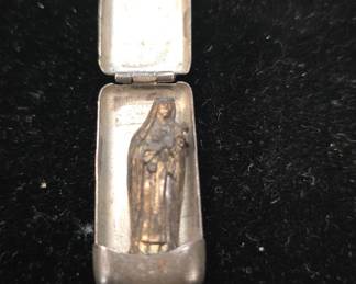 sterling little saint in a locket