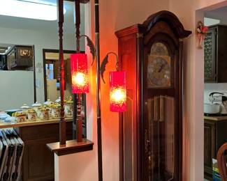 Mid-Century Modern tension pole lamp with red, textured glass shades and dark wood accents. Howard Miller grandfather Clock 
