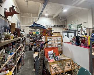 outside warehouse space full of collectibles (brass/sports memorabilia shelf!)