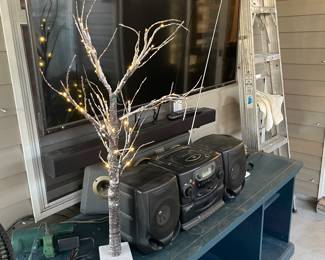 Large tv, stand, lighted small tree