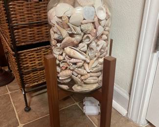 Pretty shells in large jar with stand