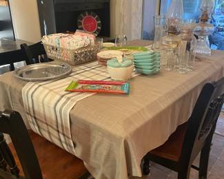 Tall table 4 bar height chairs. Pretty dishes and glasses