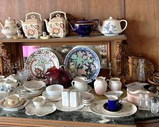 Decorative plates, teapots, cups, and more are shown here.