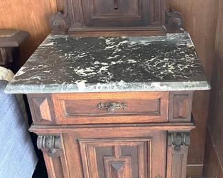 This is one of two marble-topped cabinets serving as nightstands.