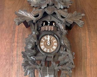 Here we have a wall clock with three small figures shown on their balcony.