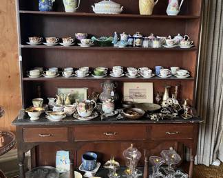 While this cabinet is showing off the cup and saucer collection, you could put other items on it.  Or add to your own cup and saucer collection!