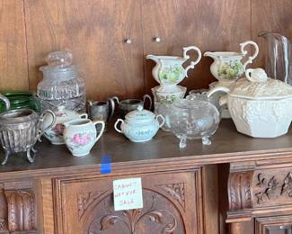 While the cabinet is not for sale, the teapots on top definitely are.
