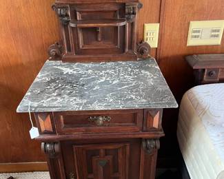 This is the second of the two marble-topped nightstands.  The clock is nice, too.