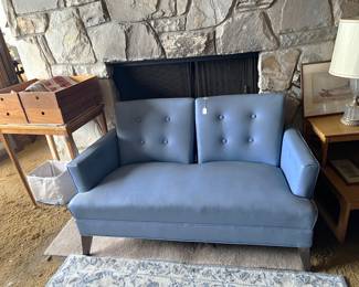 This blue loveseat looks to be in great shape.  Don't forget the lamp and the side tables.
