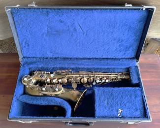 This is a much-loved, well-used Evette alto sax.  There is a neck and mouthpiece (ligature) in the small box in the case.  
