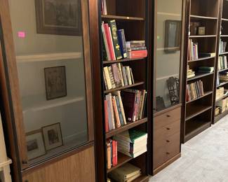 There are two glass-fronted cases shown here, along with taller bookcases.