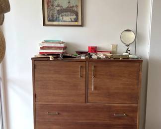In the bedroom, we have this dresser, the framed art on the wall, and more.