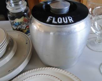 Kromex, spun aluminum (not sure on the process involved in spinning aluminum).  But it holds flour, and is in fantastic condition