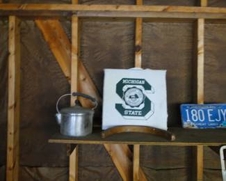 A kettle, perfect for a stove top for humidity, a State Seat Cushion, and a Michigan License plate