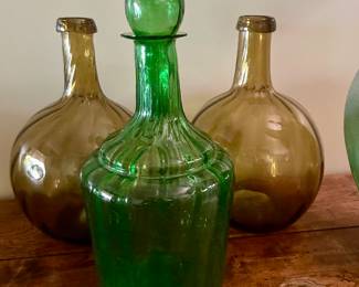 Vintage Mexican blown glass amber swirl bottles and green Mexican vintage decanter.