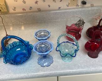 Blue and red Fenton glass pieces.