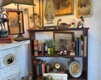 antique bookshelf, vintage books, candlesticks, lamps, vintage framed photographs
