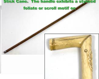 Lot 1884 Antique Carved Handle Walking Stick Cane. The handle exhibits a stylized foliate or scroll motif on
