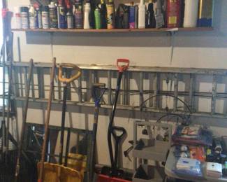 Snow shovels, cleaning supplies, small grey shelf