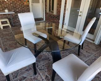 Round glass top table with four chairs with slip covers
$320