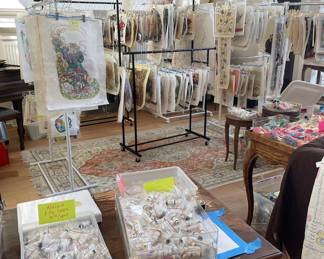 Room view of over 100 hand painted needlepoint canvases & thousands of threads