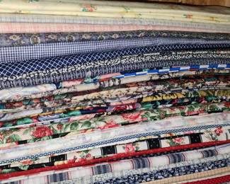 Stacks and totes of fabrics in this home!  If weather permits, we will have tables outside full of fabric items.