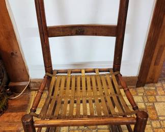 Beautiful Wood Rocking Chair with Metal Strips for seat area, notice the metal cover/tips on top of each wood piece. 