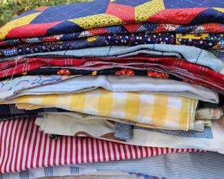 Stacks and totes of fabrics in this home!  If weather permits, we will have tables outside full of fabric items
