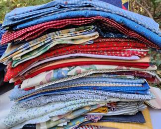 Stacks and totes of fabrics in this home!  If weather permits, we will have tables outside full of fabric items