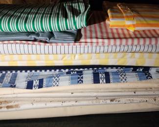 Stacks and totes of fabrics in this home!  If weather permits, we will have tables outside full of fabric items