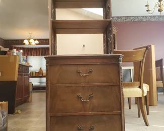 This 5' x 20" open shelf curio will fit just about anywhere.  Three drawers below.