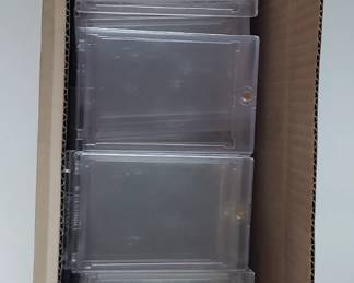 Close to 100 magnetic and screw down plastic top loader protectors.
