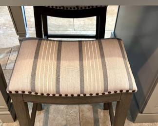 $100 Gray and white striped upholstered bench with nailhead trim. 18L x 12W x 24H. There are 2 available.