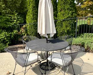 $500 Woodard patio set with 4 chairs and umbrella. Umbrella approx. 8 feet in diameter when opened. Table is 48D x 29H. Chairs 26L x 29W x 31H. Umbrella shows wear, included should you want it :)