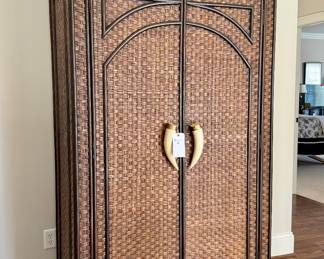 $150 Wicker armoire with faux tusk handles, as is. Inside shows wear. 41L x 22W x 80H