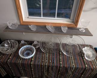 Glass serving dishes - etched bowl, frosted bowl with matching candle holders, two Christmas designed cake plates. Three glass spoon holders, candy dish, and candle holder.  **prices vary or one price for all**