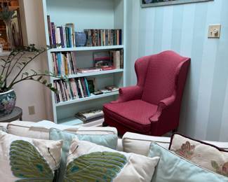 Couch, butterfly pillows, books, roses painting
