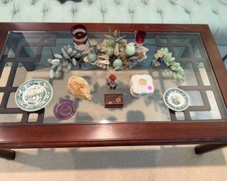 Coffee table with various vintage items, jade grapes and peaches, ruby souvenir glass