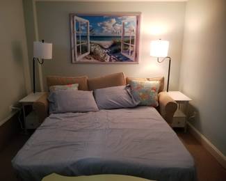 Sofa bed shown in bed mode. charging table floor lamps