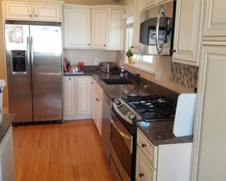 Updated cream kitchen with extensive cabinetry